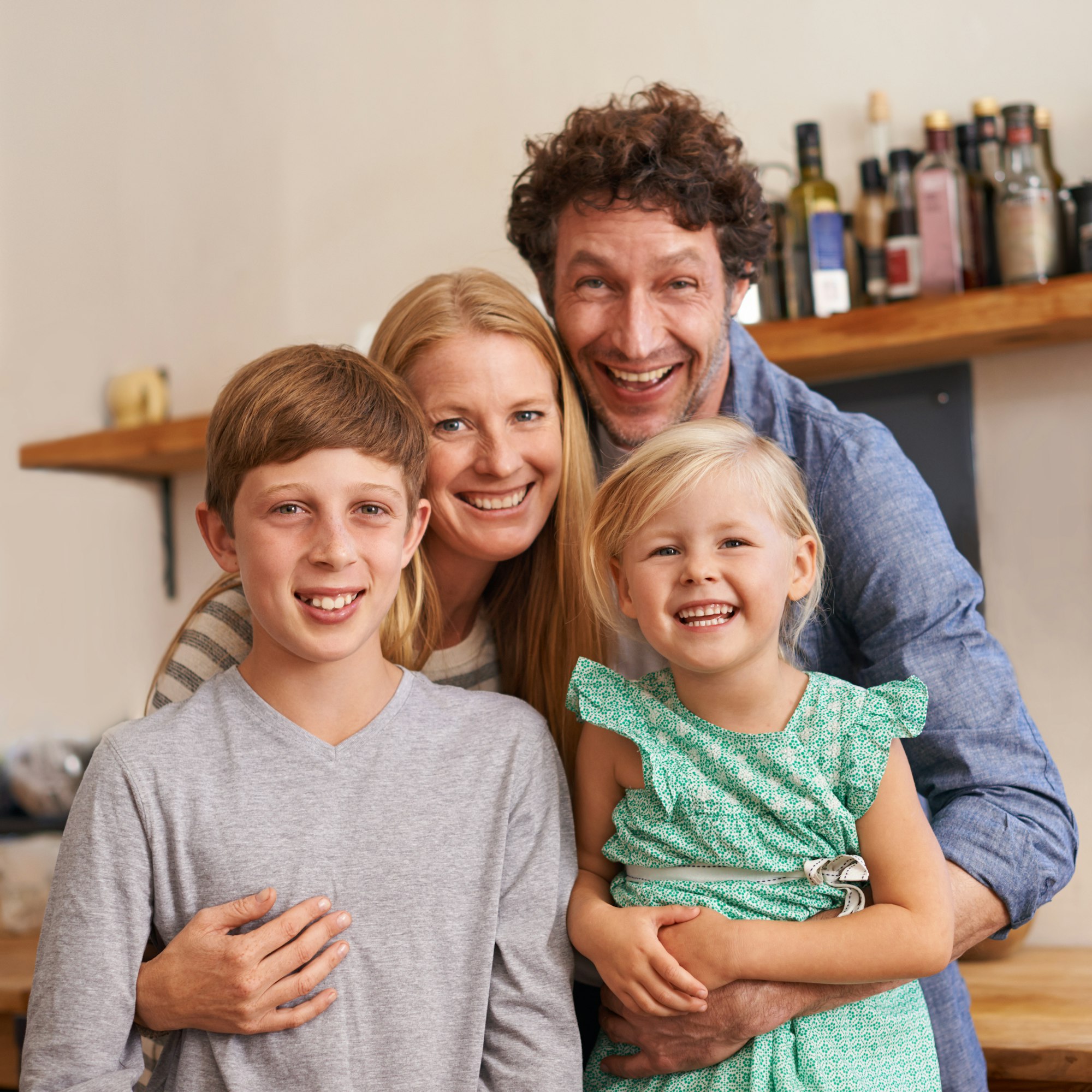 A happy and loving family. A cropped portrait of a happy family standing in their kitchen at home.