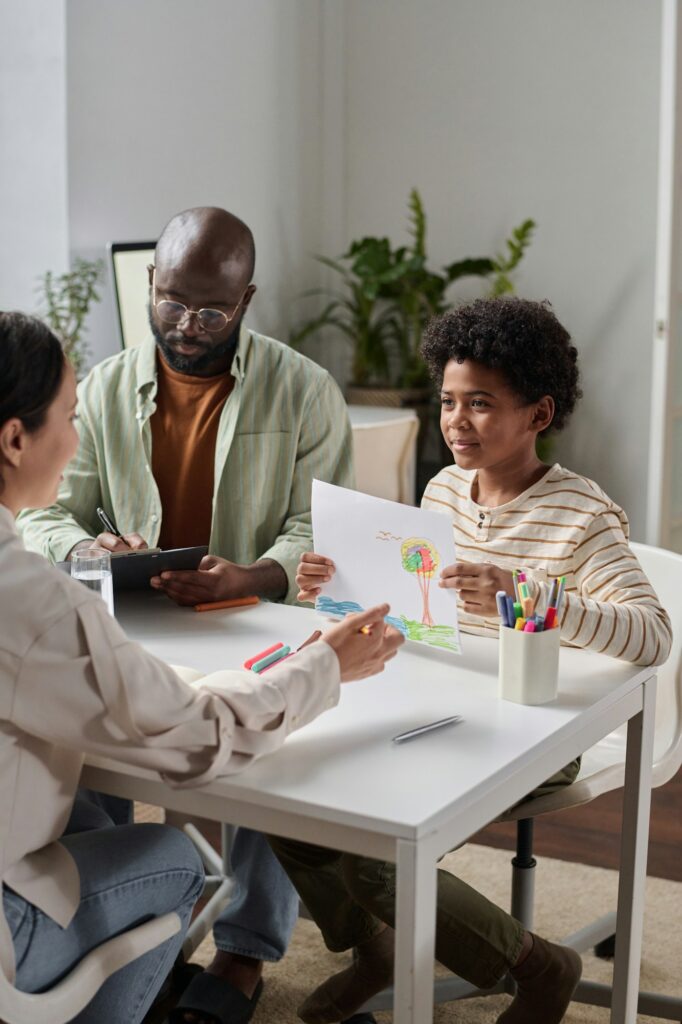 Boy Giving Drawing to Therapist