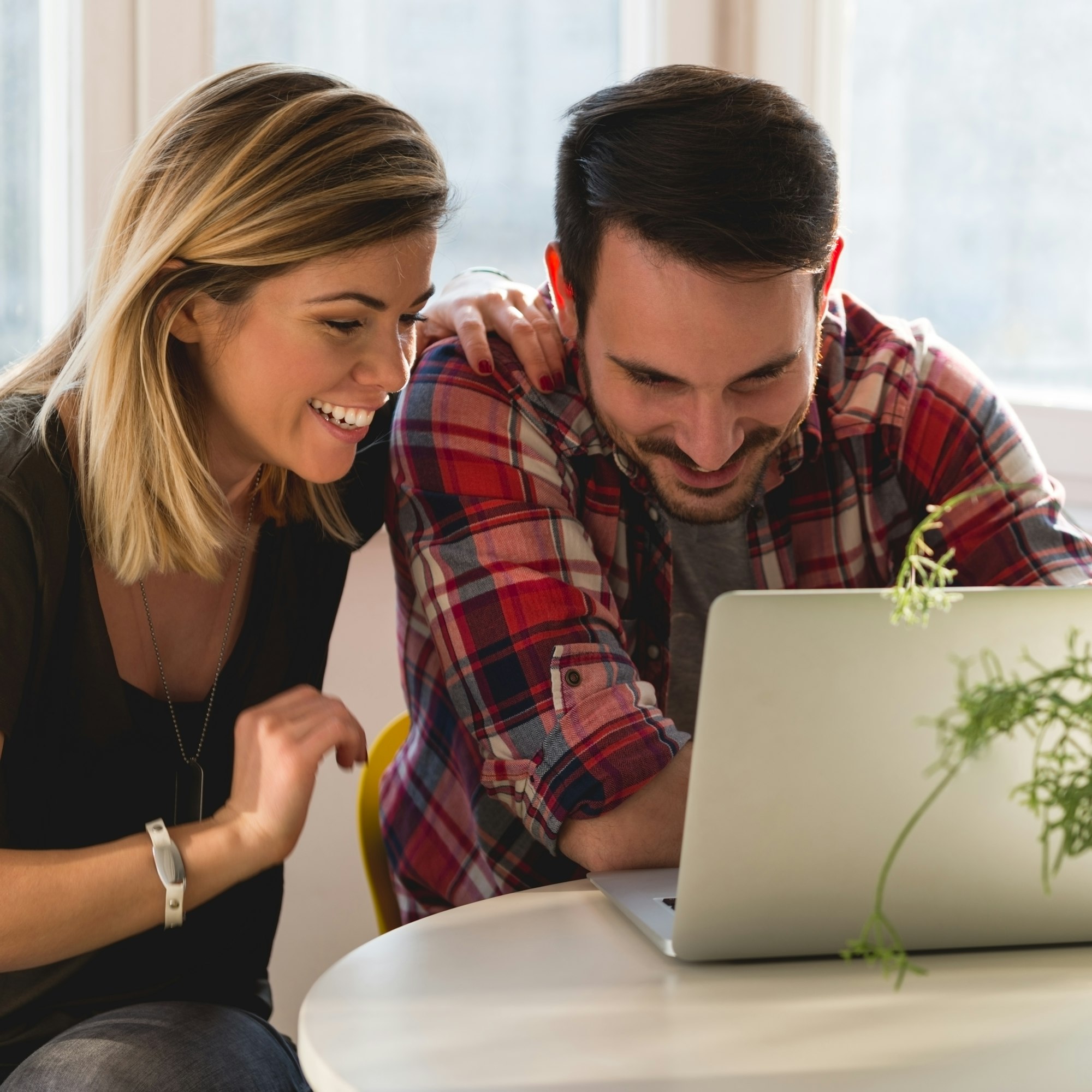 Young people looking at laptop computer