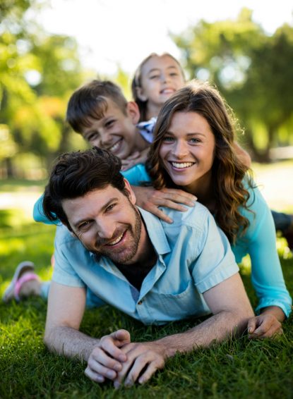 Portrait of happy family playing in park